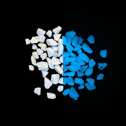 Close-up of glow-in-the-dark filter media granules showing a side-by-side comparison of natural white appearance and blue luminescent glow on a black background